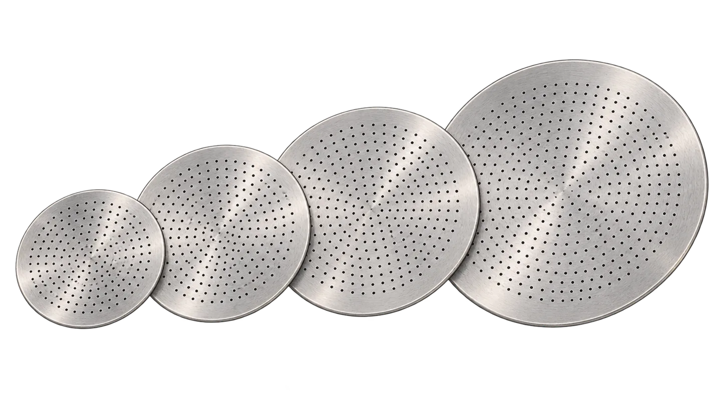 Four perforated moka pot filter plates arranged from smaller to larger.